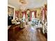 Spacious living room with hardwood floors, chandelier, large windows, and elegant furnishings at 81 Rutledge Ave, Charleston, SC 29401