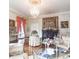Living room with elegant decor featuring a chandelier, tapestry, and ornate furniture at 81 Rutledge Ave, Charleston, SC 29401