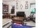 Cozy living room featuring hardwood floors, bookcase and a large TV at 81 Rutledge Ave, Charleston, SC 29401
