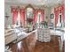 Living room featuring a chandelier, decorative curtains, and fireplace, blending classic charm at 81 Rutledge Ave, Charleston, SC 29401