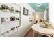 Charming living area with decorative shelving, floral arrangements, and a view of the adjacent room at 81 Rutledge Ave, Charleston, SC 29401