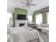 Bright main bedroom with a decorative fireplace, ceiling fan, and multiple windows at 81 Rutledge Ave, Charleston, SC 29401