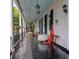 Inviting porch featuring columns, shutters, and charming decor, perfect for outdoor relaxation at 81 Rutledge Ave, Charleston, SC 29401