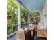 Relaxing porch with wooden furniture overlooking lush foliage, perfect for enjoying serene outdoor moments at 81 Rutledge Ave, Charleston, SC 29401