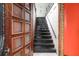 Classic wooden staircase with decorative door showcasing entry, illuminated by pendant lighting at 81 Rutledge Ave, Charleston, SC 29401
