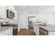 Bright, modern kitchen featuring stainless steel appliances, granite counters and white cabinetry at 810 Long Bluff Rd, Summerville, SC 29486