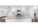 Modern kitchen with white cabinets, a granite island, stainless steel appliances, and hardwood floors at 810 Long Bluff Rd, Summerville, SC 29486
