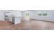 Bright living space with wood-style floors, connecting the kitchen with an island and stainless appliances at 810 Long Bluff Rd, Summerville, SC 29486