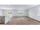 Open concept living room with natural light, wood-style flooring, and sliding door access to the outside at 810 Long Bluff Rd, Summerville, SC 29486