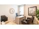 Bright home office with a modern desk, stylish seating, and a large decorative wall clock at 812 Long Bluff Rd, Summerville, SC 29486