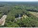 Aerial view of house situated among trees and farm land at 820 Old Cordesville Rd, Moncks Corner, SC 29461