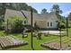 Backyard with garden plots, string lights, covered parking and fire pit for outdoor enjoyment at 820 Old Cordesville Rd, Moncks Corner, SC 29461