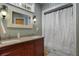 Well-lit bathroom featuring double sinks, decorative mirrors, and a shower with a curtain at 820 Old Cordesville Rd, Moncks Corner, SC 29461
