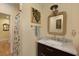 Charming bathroom featuring a vanity with a marble countertop, framed mirror, and decorative shower curtain at 820 Old Cordesville Rd, Moncks Corner, SC 29461