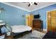 Stylish blue bedroom with a queen bed, mounted TV, antique dresser and ample closet space at 820 Old Cordesville Rd, Moncks Corner, SC 29461
