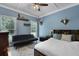 Comfortable bedroom featuring a futon, queen bed, ceiling fan, and natural light from two windows at 820 Old Cordesville Rd, Moncks Corner, SC 29461