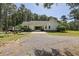 Traditional style home with a carport and gravel driveway surrounded by lush greenery at 820 Old Cordesville Rd, Moncks Corner, SC 29461