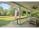 Cozy porch area with ferns, table and seating, perfect for enjoying outdoor scenery at 820 Old Cordesville Rd, Moncks Corner, SC 29461