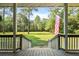 Inviting view of a lush green lawn and trees from the home's welcoming front porch at 820 Old Cordesville Rd, Moncks Corner, SC 29461