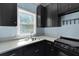 Galley kitchen with white countertops, dark cabinets, and stainless steel sink at 820 Old Cordesville Rd, Moncks Corner, SC 29461