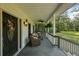 Relax on the spacious covered porch with wooded views and comfortable wicker furniture at 820 Old Cordesville Rd, Moncks Corner, SC 29461