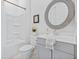 Cozy bathroom featuring a gray vanity, round mirror, and tiled tub provides functionality and style at 840 Forrest Dr, Charleston, SC 29492