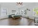 Bright bedroom featuring hardwood floors, a ceiling fan, and large windows for natural light at 840 Forrest Dr, Charleston, SC 29492