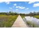 Long private wooden dock extends to the calm waters edge at 840 Forrest Dr, Charleston, SC 29492