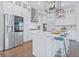 Beautiful white kitchen features stainless steel appliances and a large center island with seating at 840 Forrest Dr, Charleston, SC 29492