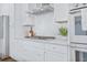 Bright kitchen featuring white cabinets, countertops, and stainless steel appliances at 840 Forrest Dr, Charleston, SC 29492