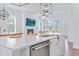Open concept kitchen with island seating, stainless steel appliances, and fireplace in the background at 840 Forrest Dr, Charleston, SC 29492
