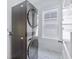 Modern laundry room featuring a stacked washer and dryer and bright, natural light from a window at 840 Forrest Dr, Charleston, SC 29492