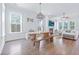 Spacious living room features a large wood table with bench seating, hardwood floors, and natural lighting at 840 Forrest Dr, Charleston, SC 29492