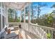 Relaxing screened porch with comfortable seating offers views of the surrounding trees at 840 Forrest Dr, Charleston, SC 29492