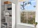 Built-in shelves provide organization, while the window offers views of the natural landscape outside at 840 Forrest Dr, Charleston, SC 29492