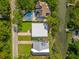 Beautiful aerial view of homes, pool, lush green lawn, and adjacent waterway at 1012 E Erie Ave, Folly Beach, SC 29439