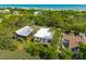 Stunning aerial view of coastal homes surrounded by lush greenery near the beautiful ocean at 1012 E Erie Ave, Folly Beach, SC 29439