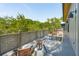 Outdoor back deck with views of treetops, outdoor seating, and exterior lighting at 1012 E Erie Ave, Folly Beach, SC 29439