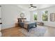 This bedroom features a ceiling fan, large windows, and stylish decor with a patterned rug at 1012 E Erie Ave, Folly Beach, SC 29439