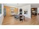 Inviting dining room with wood paneling, surfboard, and arched entry to the modern kitchen at 1012 E Erie Ave, Folly Beach, SC 29439