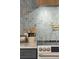 Close up of kitchen cooktop, light blue backsplash, decorative shelving, and pot filler at 1012 E Erie Ave, Folly Beach, SC 29439