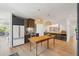 Bright kitchen boasts wood floors, dark cabinetry, and a large butcher block island with decorative hanging lights at 1012 E Erie Ave, Folly Beach, SC 29439