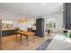 Open concept kitchen with rustic wood table, modern cabinetry, stylish decor, and light wood flooring at 1012 E Erie Ave, Folly Beach, SC 29439