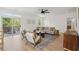 Bright living room featuring neutral furniture, patterned rug, light wood floors, and access to balcony at 1012 E Erie Ave, Folly Beach, SC 29439