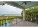 An expansive balcony with a view of the water, a pier, and part of the swimming pool at 104 Beach St, Mount Pleasant, SC 29464