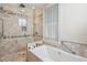 Luxurious bathroom with a shower, soaking tub, and tiled walls at 104 Beach St, Mount Pleasant, SC 29464