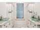Elegant bathroom with dual sinks, granite countertops, and custom cabinets at 104 Beach St, Mount Pleasant, SC 29464