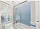 This remodeled bathroom features beautiful light blue tile in the walk-in shower and around the window at 104 Beach St, Mount Pleasant, SC 29464