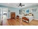 A comfortably furnished bedroom with two beds and antique wooden furniture and hardwood floors at 104 Beach St, Mount Pleasant, SC 29464