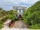 Charming home with a lush front yard, complemented by beautiful landscaping and inviting curb appeal at 104 Beach St, Mount Pleasant, SC 29464